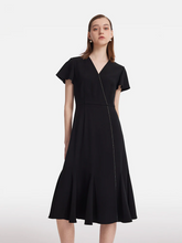 a lady in a black triacetate v-neck ruffle midi dress